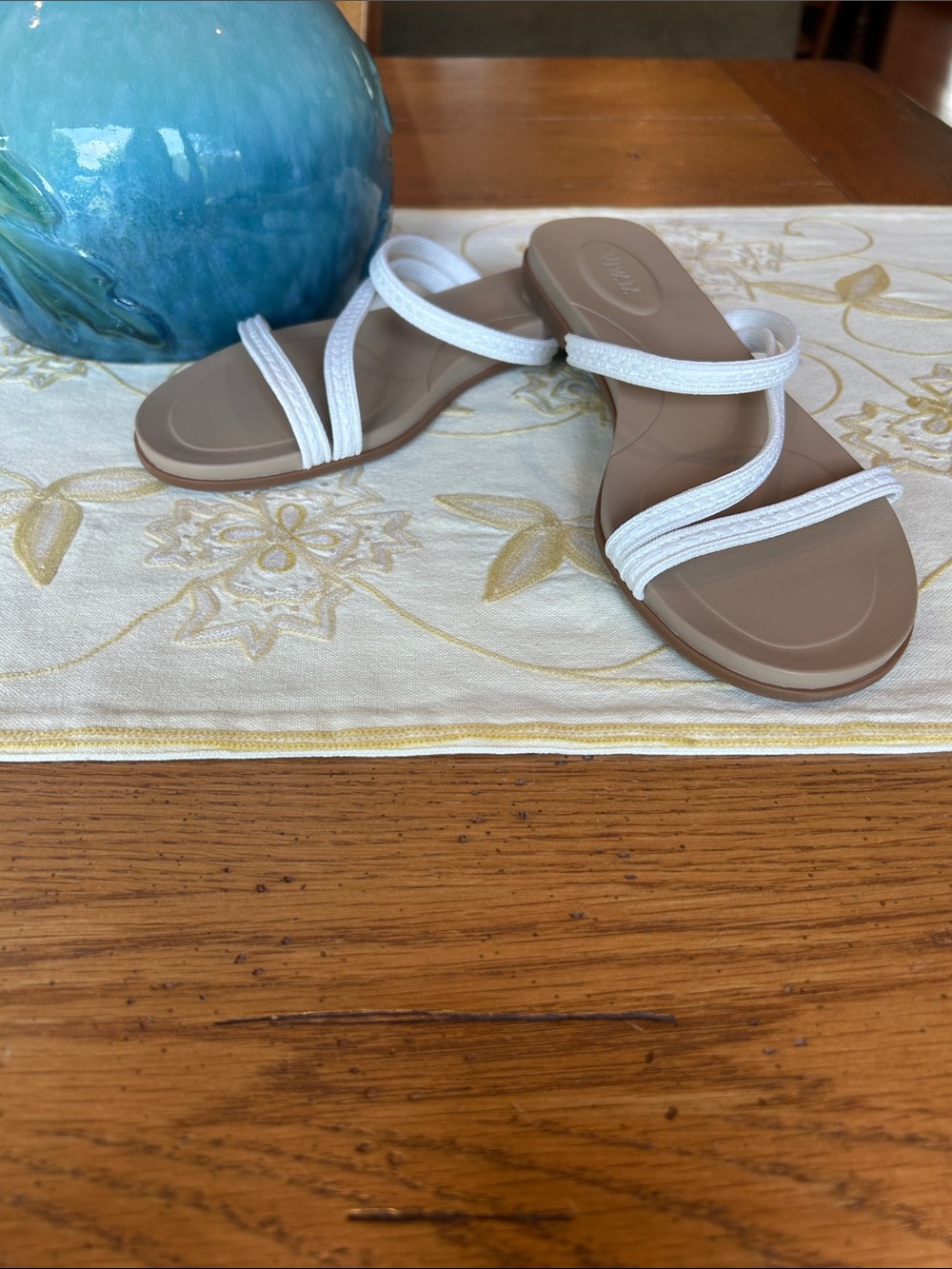 Vivaia cream flip flops.